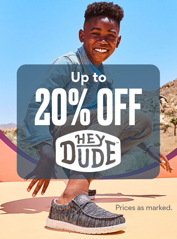boy squatting down wearing heydude shoes on sale. up to 20% off heydude