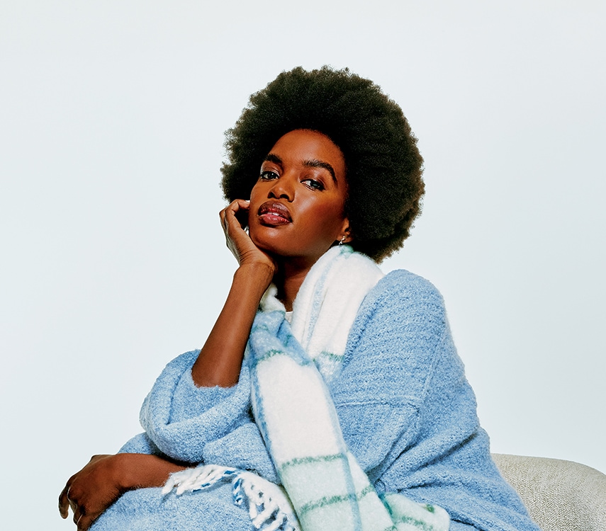 woman wearing a blue sweater and scarf